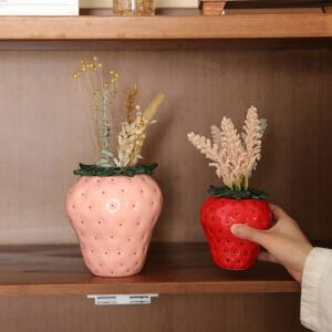 alt=“Pink and red Strawberry Ceramic Vases displaying dried flowers”