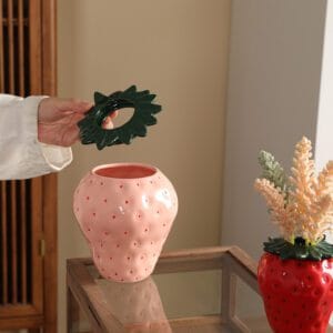 alt=“Pink and red Strawberry Ceramic Vases displaying dried flowers”